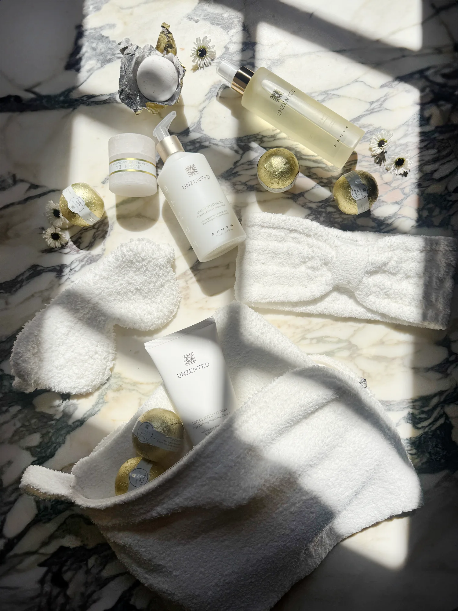 ZENTS bath and body products arranged with soft white Kashwére spa accessories