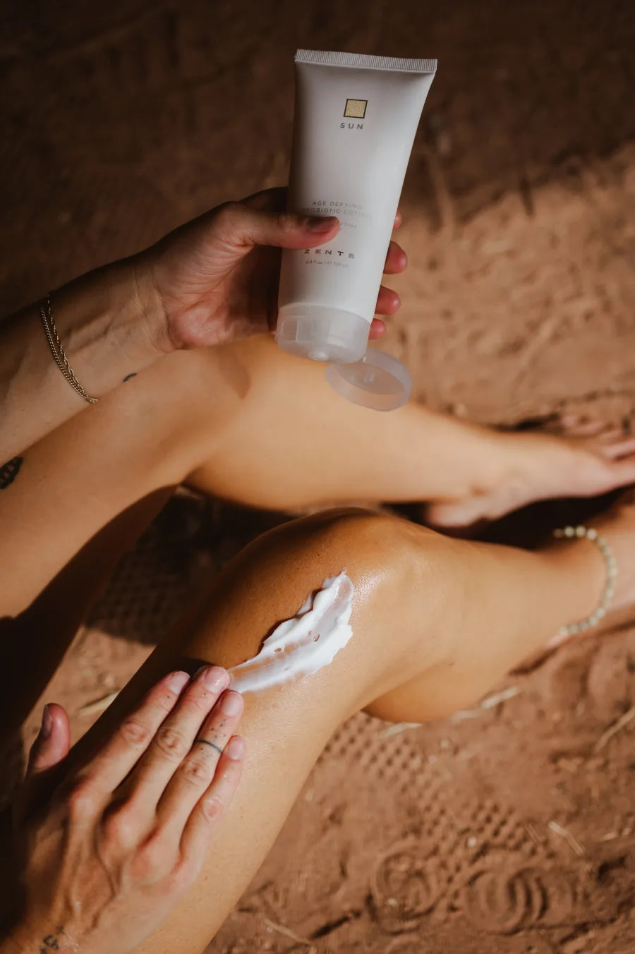 ZENTS body care arranged on warm mineral stone